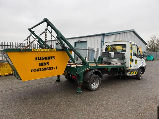 Allsorts skip lorry lifting a mini skip
